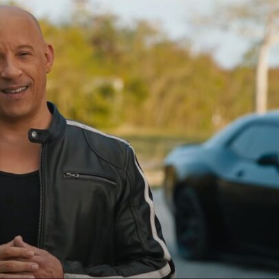 Vin Diesel, having driving a muscle car out to the middle of nowhere, addresses a camera